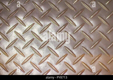 Rusty steel diamond plate texture background. Grungy metal floor seamless of steel sheet metallic. Seamless metal floor plate with diamond pattern. Stock Photo