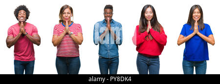 Composition of african american, hispanic and chinese group of people over isolated white background praying with hands together asking for forgivenes Stock Photo