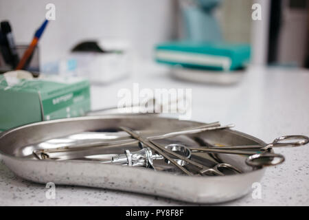 medical instruments in the tray, disposable gloves on the table. health, longevity, Stock Photo