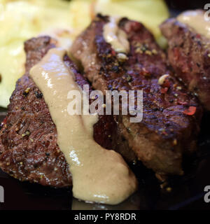 Spiced fillet steak with creamy peppercorn sauce. Close up square shape image. Stock Photo