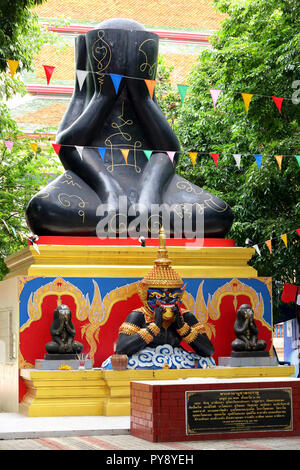 Phra Pidta (closed eyes buddha) and Phra Rahu at Thai temple Stock Photo