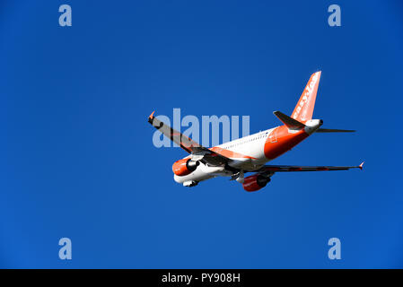 easyJet Airbus A319 111 G-EZFV jet plane climbing out into blue sky from London Southend Airport, Essex, UK. Budget airline Stock Photo