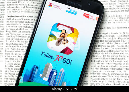 Vatican releases the smartphone app 'Follow JC GO!' (Follow Jesus Christ), which is almost identical to the model Pokémon Go. Instead of monsters, saints are now being sought and catched in the Vatican game. The game is currently only available in Spanish, other language versions will be released shortly. Photo shows login page of 'Follow JC GO!' on a smartphone. Stock Photo