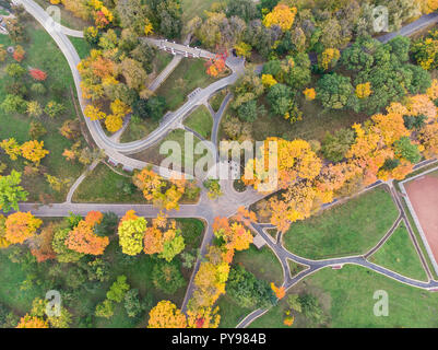aerial view of park landscape with footpaths, yellow trees and green lawns Stock Photo