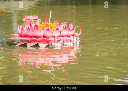 Beautiful pink kratong is floating on the water. Conccept for loy kratongs festival celebrated in Thailand. Stock Photo