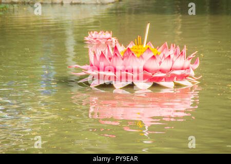 Beautiful pink kratong is floating on the water. Conccept for loy kratongs festival celebrated in Thailand. Stock Photo