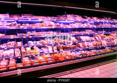 Sausages in shop. Wide choice of different sausages and meat products on shelves of shop. Sausages in shop. Stock Photo