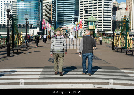 18.09.2018, Sydney, New South Wales, Australia - Pedestrians cross the Pyrmont Bridge over Cockle Bay in Darling Harbour. Stock Photo