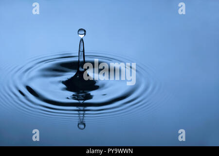 Drop of water creating ripples Stock Photo