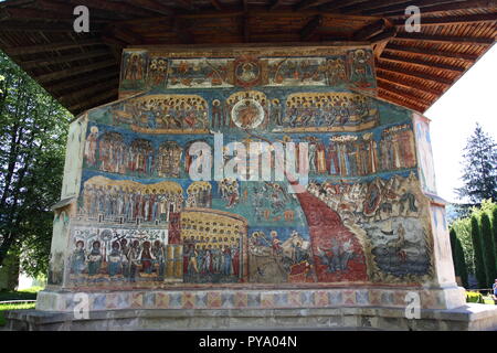 Frescoes on exterior of Voronet Monastery Church, painted using Voronet Blue paint, part of the Bucovina Monastery group in Romania Stock Photo