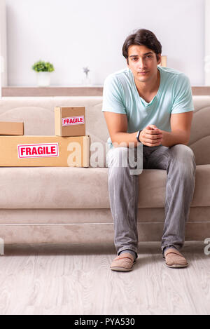 Man opening fragile parcel ordered from internet Stock Photo