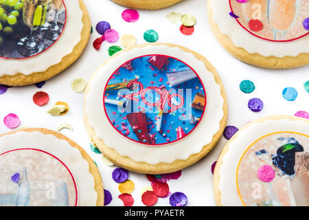 New Year cookies and confetti on white background Stock Photo