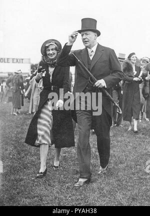 Coco Chanel , 1883-1971. French fashion designer and business woman. Founder and namesake of the Chanel brand with it's signature scent Chanel No. 5. Pictured here at the Epsom Derby horseracing event, together with the Duke of Westminster. May 31 1933 Stock Photo