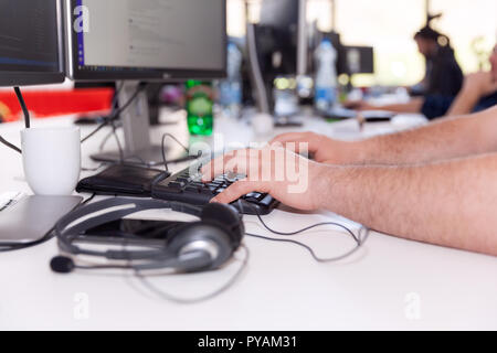 Software developer, programmer or coder working on computer in an IT office. Stock Photo