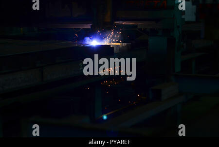 High precision CNC gas cutting metal sheet.  Plasma cutting. Industrial plasma machine cutting of metal plate. Laser cutting with sparks. Stock Photo