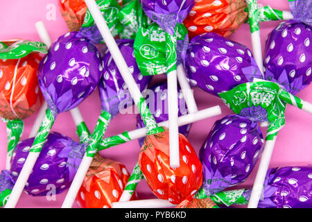 Swizzels Sweet Shop Favorites on a pink background featuring love hearts, lolly pops, parma violets, fizzers, drumsticks, refreshers Stock Photo