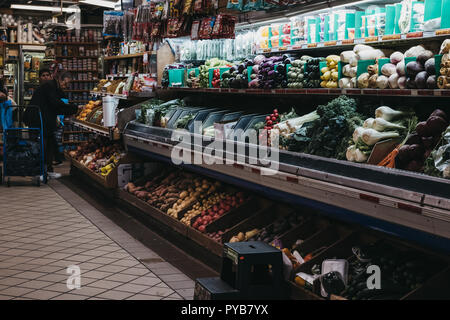 New York, USA - May 30, 2018: People buying groceries inside Essex Street Market in Lower East Side, New York. Essex Street Market is New York City's  Stock Photo