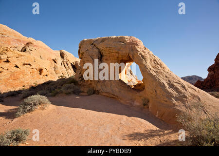 NV00051-00...NEVADA - A window through the Aztec sandstone located in the Mojave Desert along the While Domes Loop Trail in Valley of Fire State Park. Stock Photo