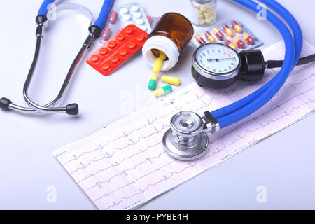 Close-up stethoscope lying on RX prescription with assorted pills. Healthy life or insurance concept. Stock Photo