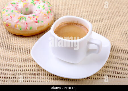 Coffee break with fresh donuts over textile background. Stock Photo