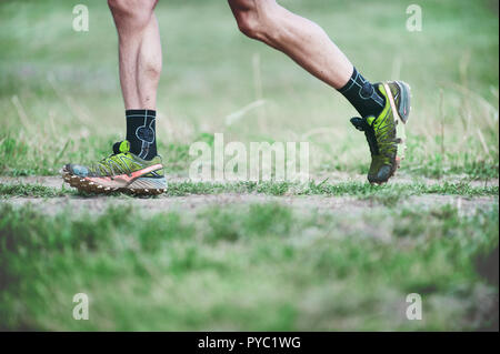 CZECH REPUBLIC, SLAPY, October 2018: Trail Maniacs Run Competition. Legs of the Runner in Green Salomon Running Shoes. Stock Photo