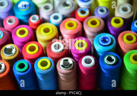 Sewing threads as a multicolored background closeup Stock Photo