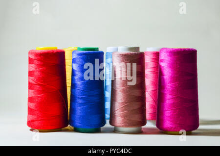 Spools with color threads. Threads of all colors. Isolated. White background. Stock Photo