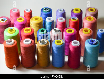 Color sewing threads on white background, top view Stock Photo