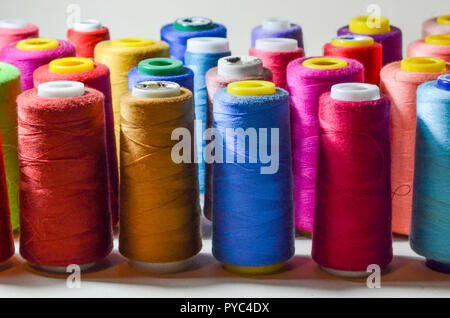 Spools of colours threads isolated on white background Stock Photo