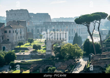 Early morning view across The Roman Forum  towards the Arch of Titus , with the Colosseum in the background, Rome, Italy. Stock Photo