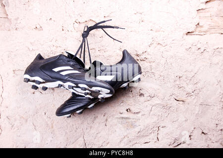 football boots hanging on the wall Stock Photo