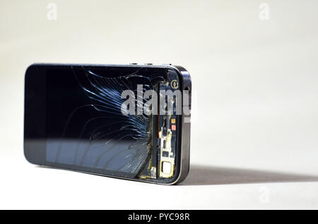 Broken glass screen of a mobile phone on a white background. Repair gadgets Stock Photo