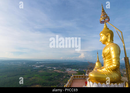 The golden Buddha at the top of mountain, Tiger Cave temple, Krabi, Thailand Stock Photo