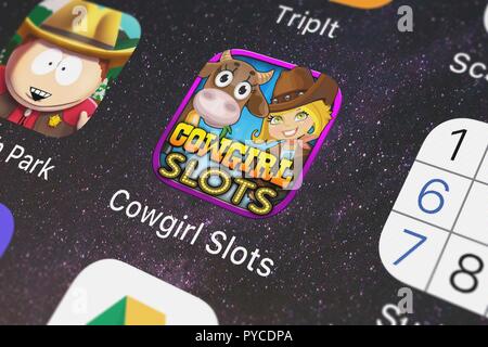 London, United Kingdom - October 26, 2018: The Cowgirl Slots - Free Casino Slot Machine Games mobile app from Psycho Bear Studios on an iPhone screen. Stock Photo