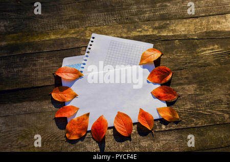 Autumn banner with red leaves of the tree on the mail envelope on a wooden background and a white sheet for your text Stock Photo