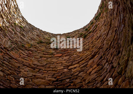 interior of a big chimney of old steel mill made of stone blocks Stock Photo