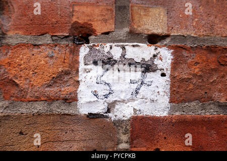 House number weathered thirty-seven 37 hand written in black permanent marker on white square on brickwork in bold modern font from Sweden Stock Photo