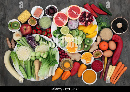 Health food for fitness concept with fresh salmon, fruit, vegetables, dairy, supplement powders, herbs and spices. Super foods high in protein, antiox Stock Photo