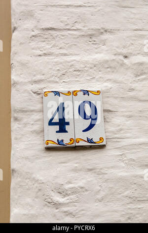House number forty-ine 49 painted on ceramic tile in blue and yellow, red and gold from Sweden Stock Photo