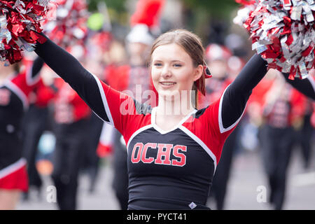 Portland, OR / USA - June 11 2016:  OCHS Cheerleader with pom-poms at the grand floral parade. Stock Photo