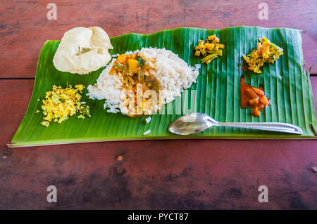 Kerala is known for its traditional banquet or sadya, a pure vegetarian meal served with boiled rice and a host of side-dishes served especially durin Stock Photo