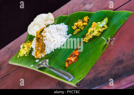 Kerala is known for its traditional banquet or sadya, a pure vegetarian meal served with boiled rice and a host of side-dishes served especially durin Stock Photo