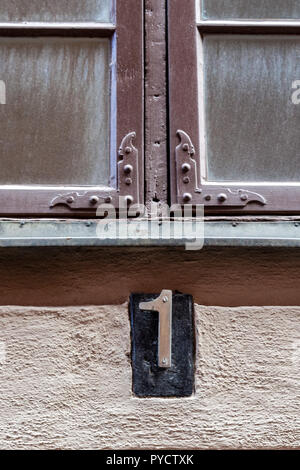 House number two hundred and forty 240 in  cut out metal, weathered and peeling white paint in designer font from Sweden Stock Photo