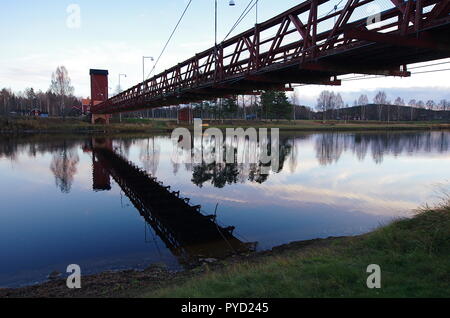 A wooden bridge spanning across a river in Dalarna. Stock Photo
