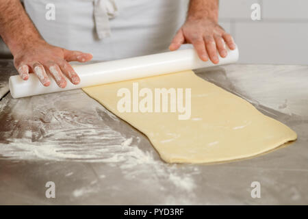 Preparing and rolling dough Stock Photo