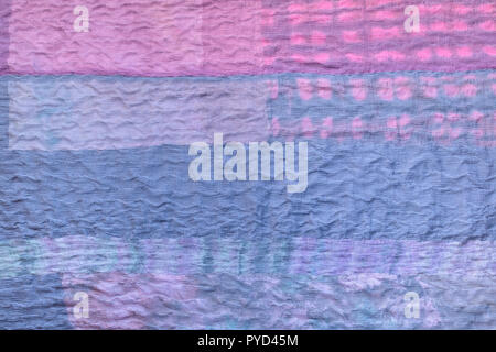 textile background from silk stitched scarf - blue back side of patchwork cloth Stock Photo
