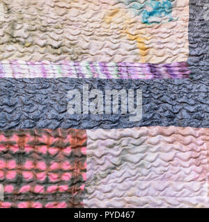 textile background from silk stitched scarf - various sewn pieces of patchwork cloth Stock Photo