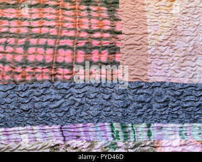 textile background from silk stitched scarf - various textured and batik pieces of patchwork cloth Stock Photo