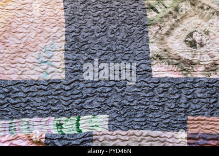 textile background from silk stitched scarf - various textured sewn pieces of patchwork cloth Stock Photo