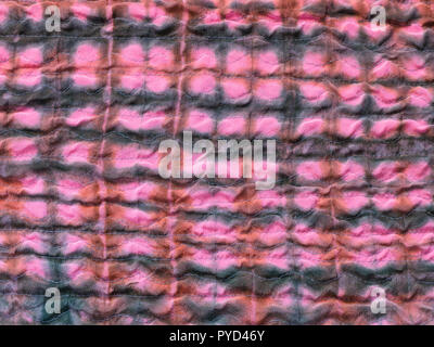 textile background from silk stitched scarf - geometric ornament on sewn batik piece of patchwork cloth Stock Photo